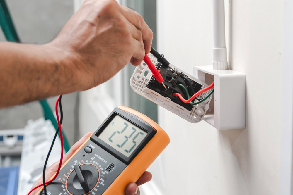 Electrician Measuring The Voltage Of An Outlet
