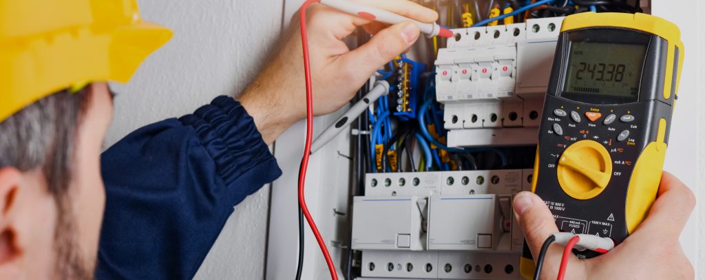 An electrician testing a switchboard in a home in Port Macquarie